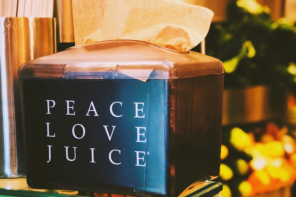 box with peace love juice message